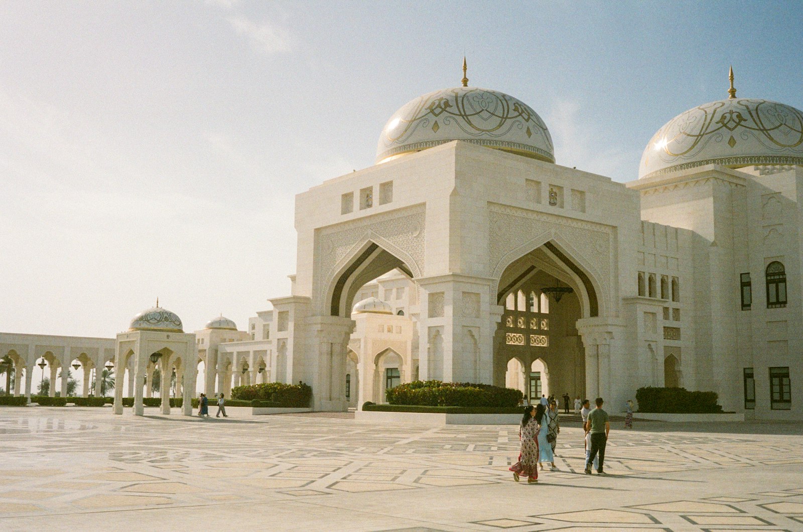 Grand white building with domes and arches