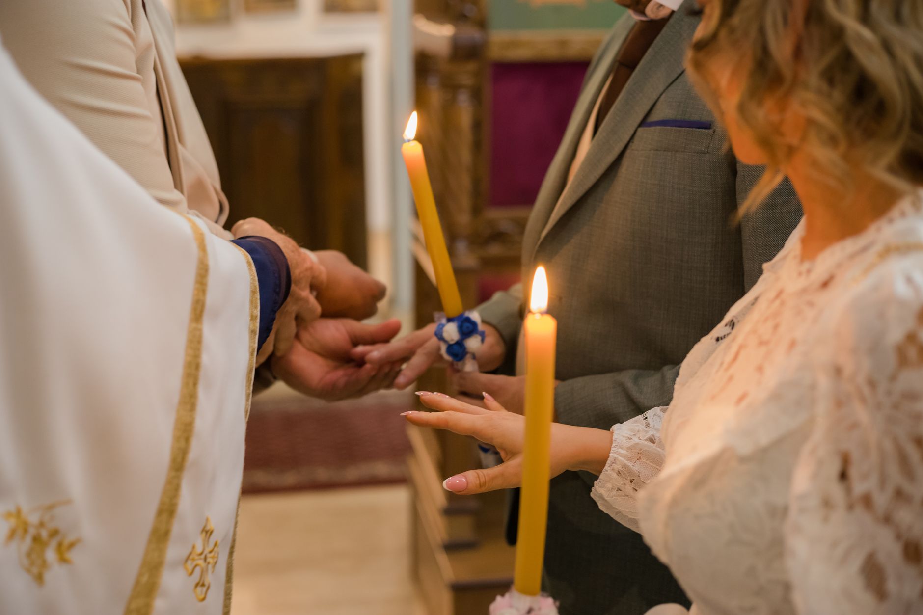 Close-up of traditional Serbian Orthodox wedding with candle lighting ritual.
